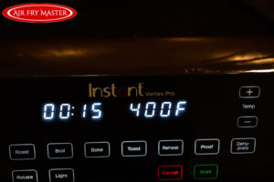 Time and temperature displayed on the front of the air fryer.